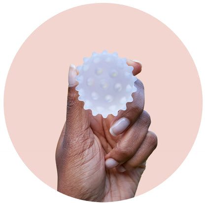 Woman holding Lactamo breastfeeding support device