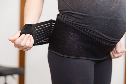 Pregnant woman wearing GRDL support belt during everyday activity